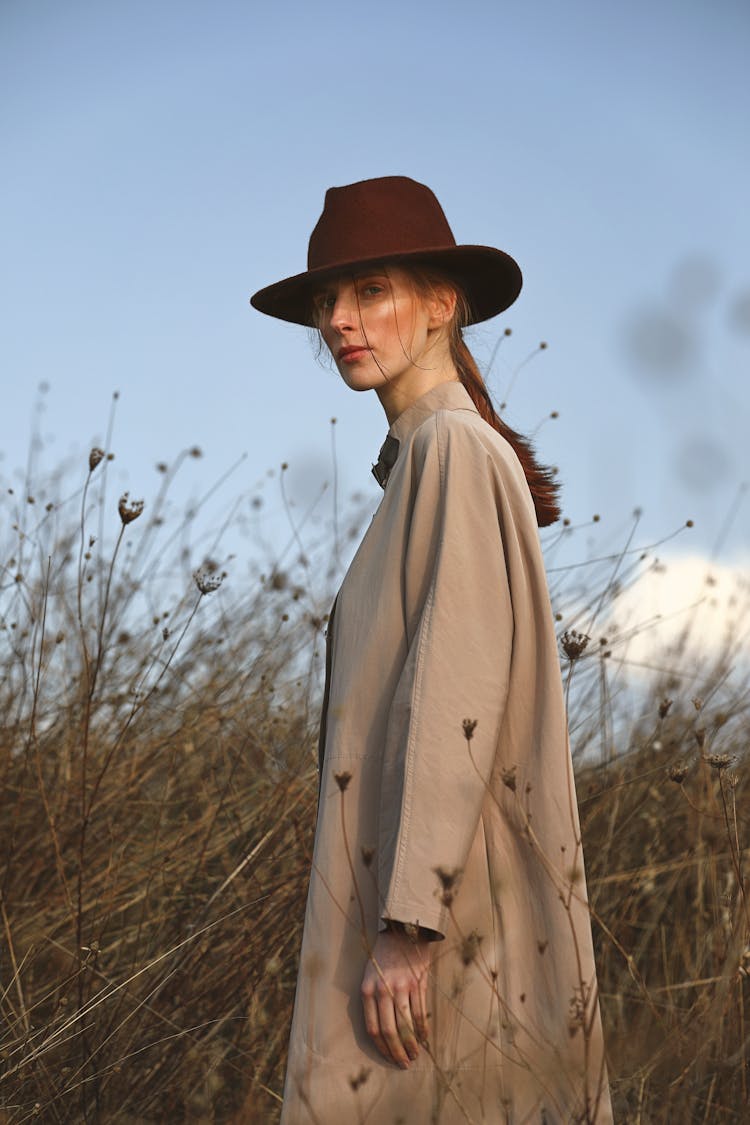 Woman In Brown Coat Wearing Hat