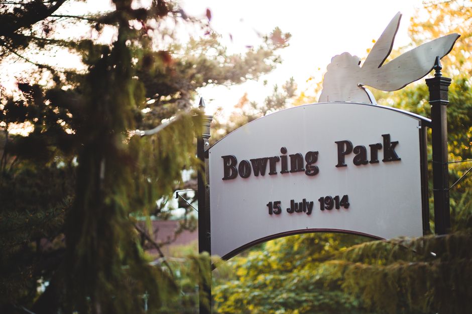 Sign at Bowring Park with date 15 July 1914, surrounded by trees.