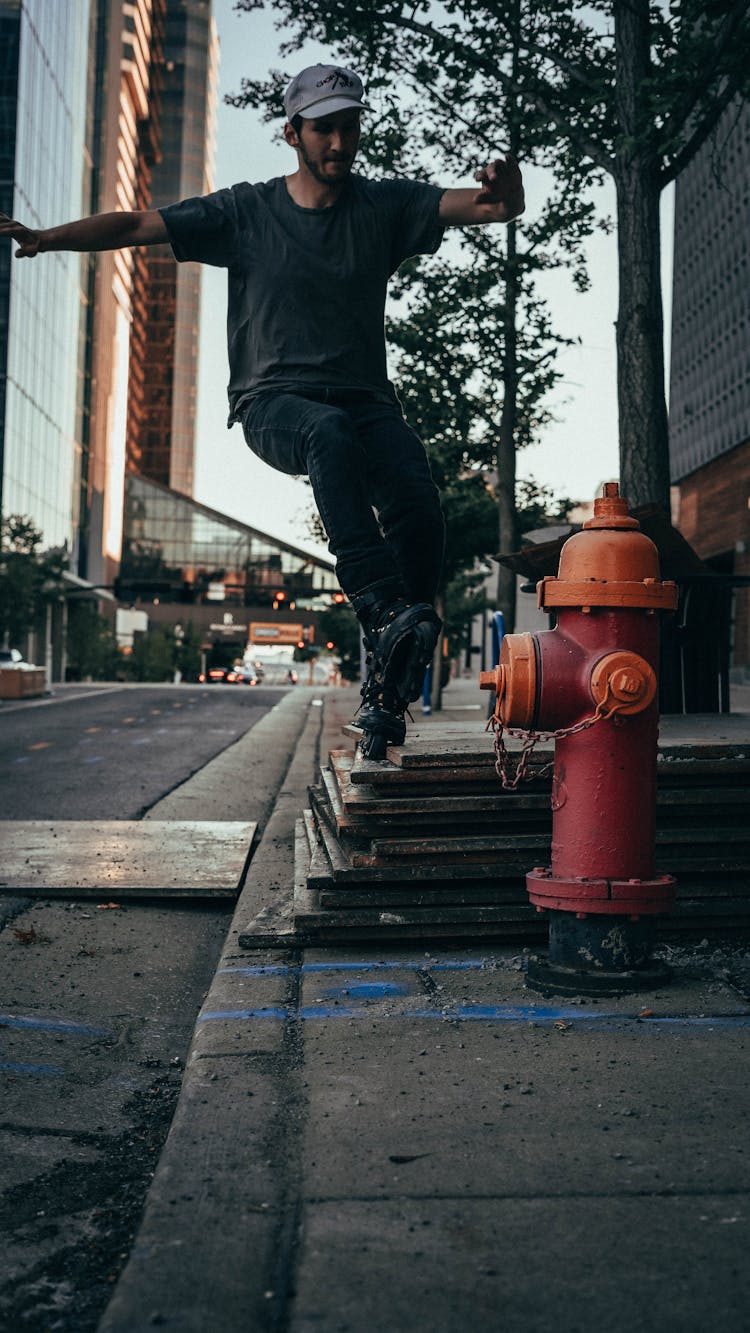 Man Wearing Rollerblades Doing A Trick