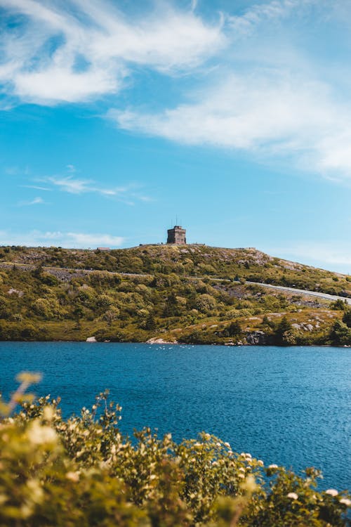 Tower on a hill and Lake under a Blue Sky 
