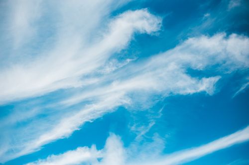 Free A captivating view of blue sky adorned with flowing white clouds, evoking a sense of tranquility. Stock Photo