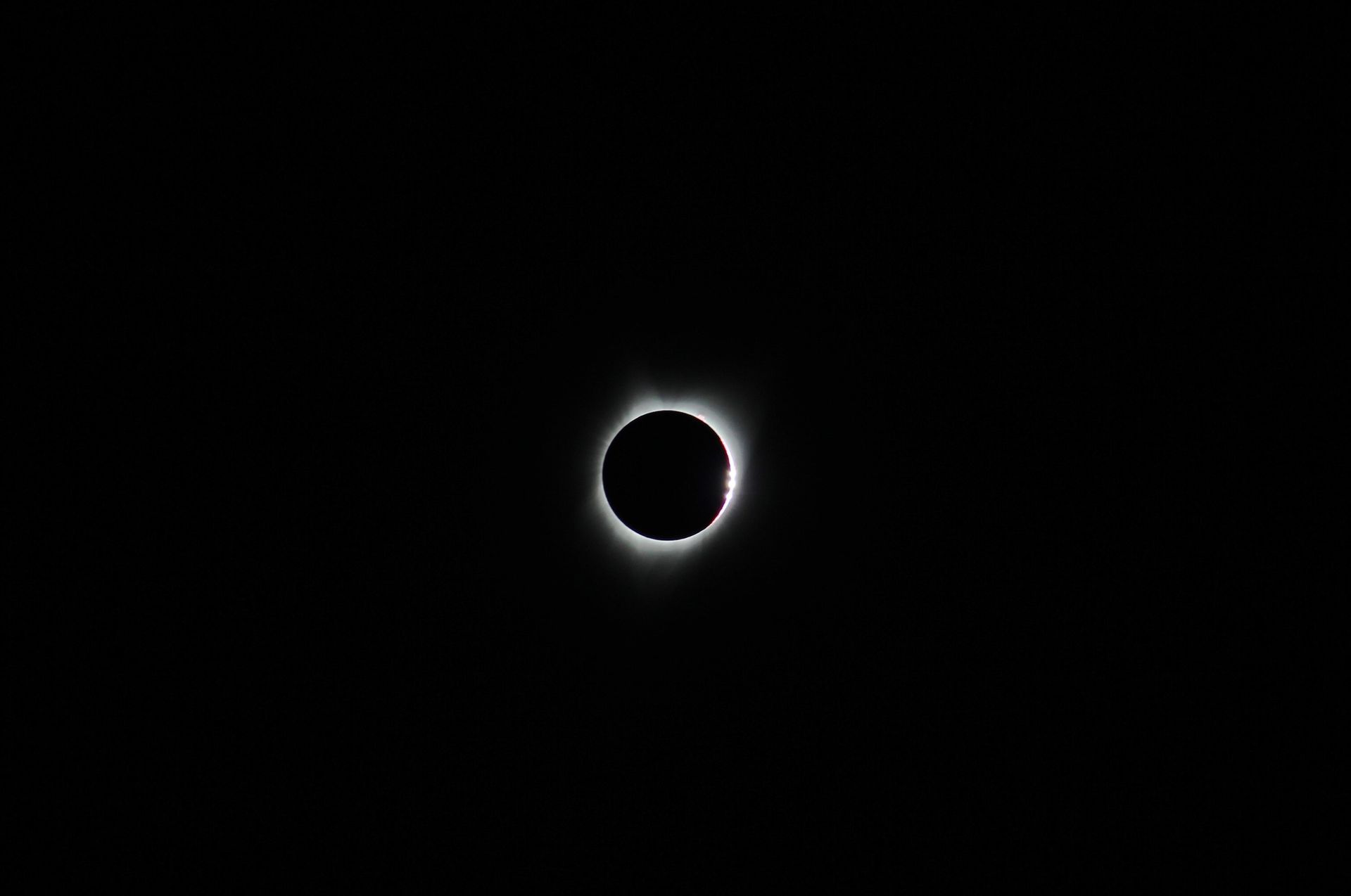 Experiencing a breathtaking total solar eclipse with a dark sky backdrop in Oregon, USA.