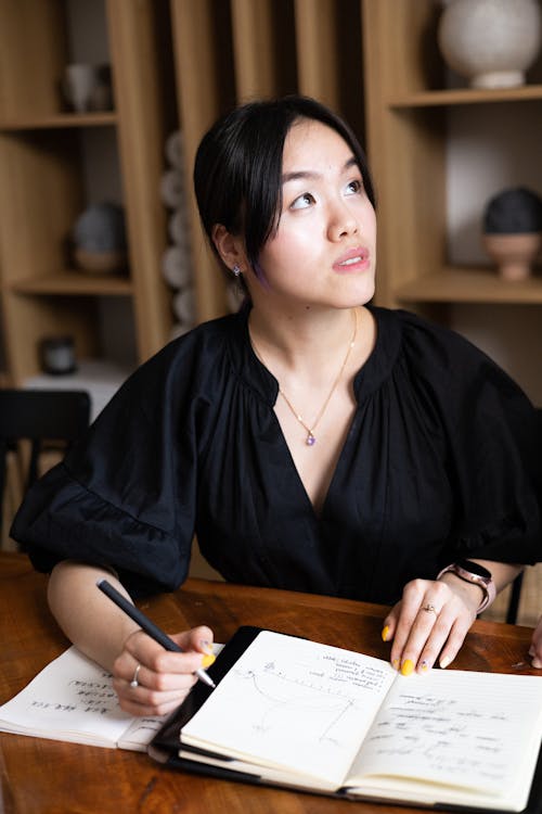 A Woman Wearing a Black Top while Looking Up