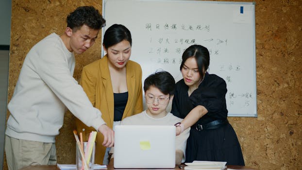 A group of young professionals brainstorming ideas during a meeting in a modern office setting.