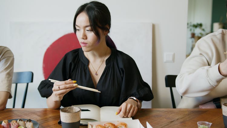 A Woman Eating Japanese Food 