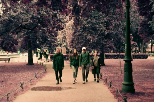 Free A group of friends walks through a scenic autumn park, surrounded by trees and foliage. Stock Photo