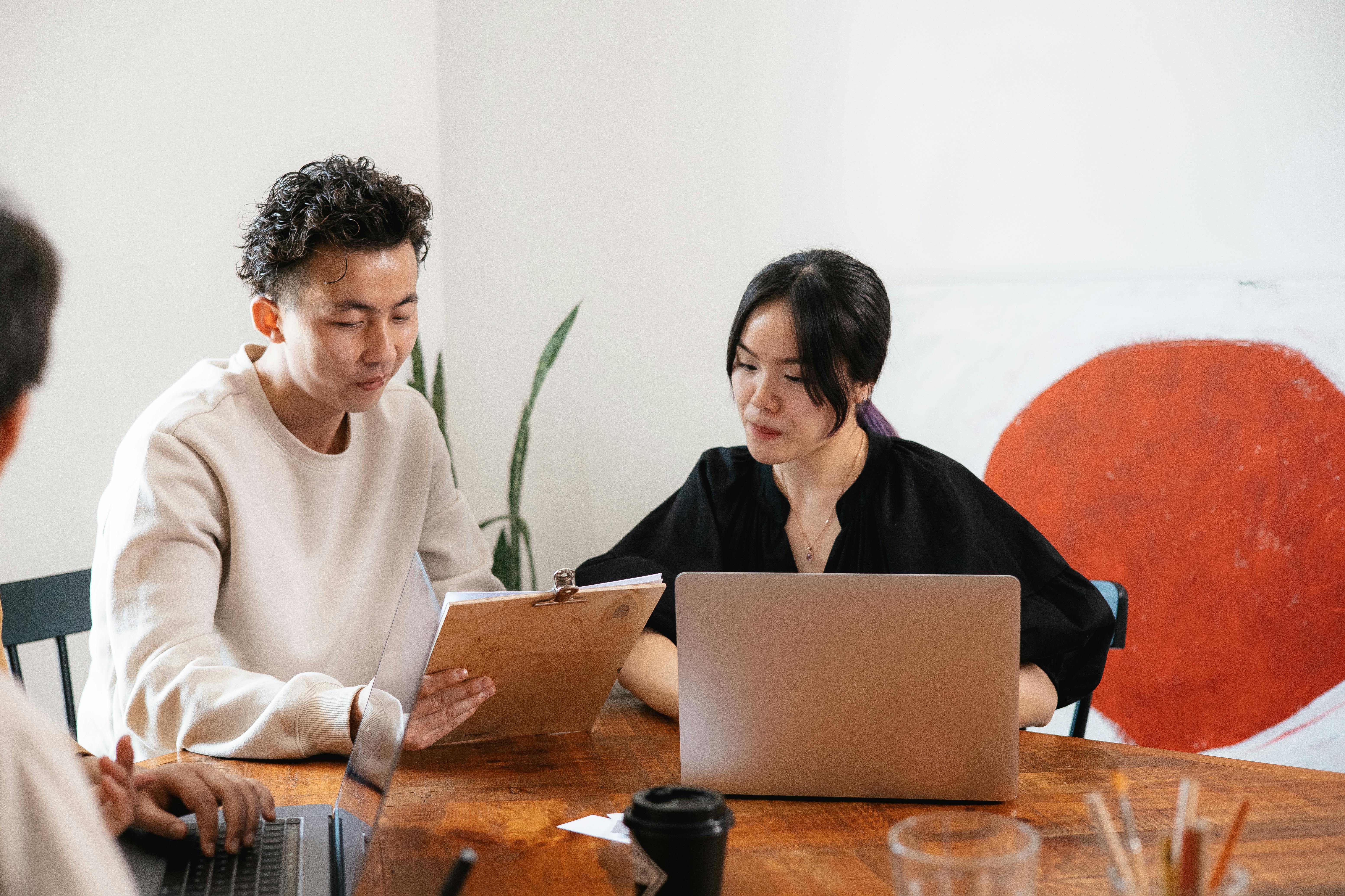 Woman in Black Long Sleeve Shirt Using Silver Laptop
