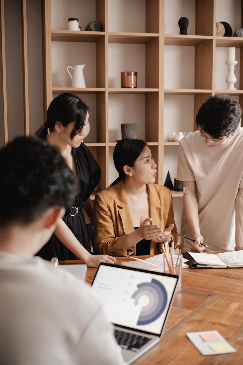 A group of professionals in a business meeting discussing data charts and strategies.