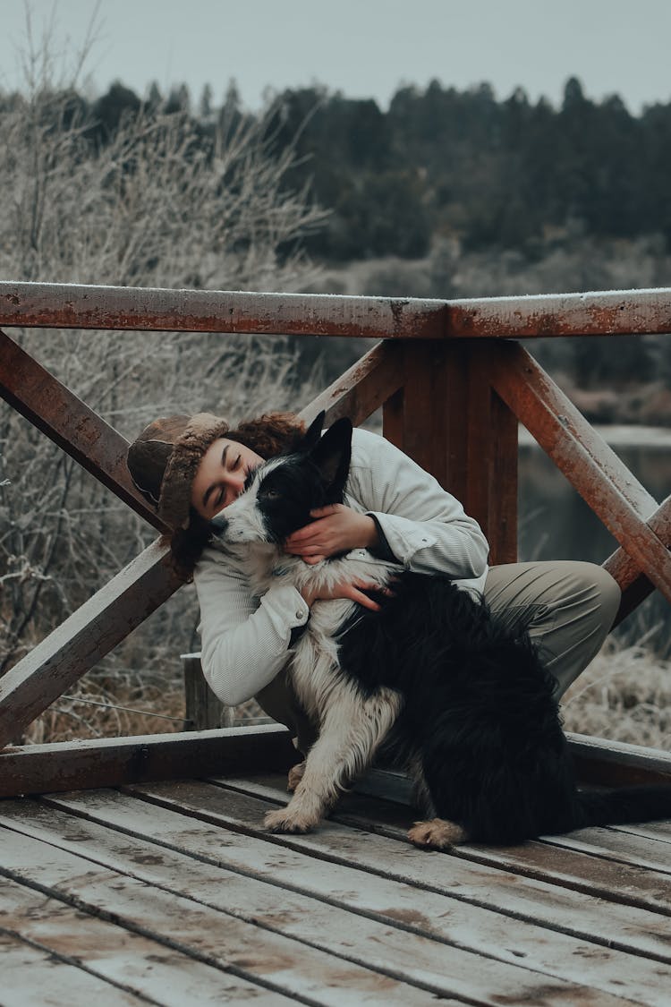 Woman Kissing A Dog