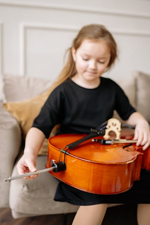 A Girl in Black Dress Playing Cello