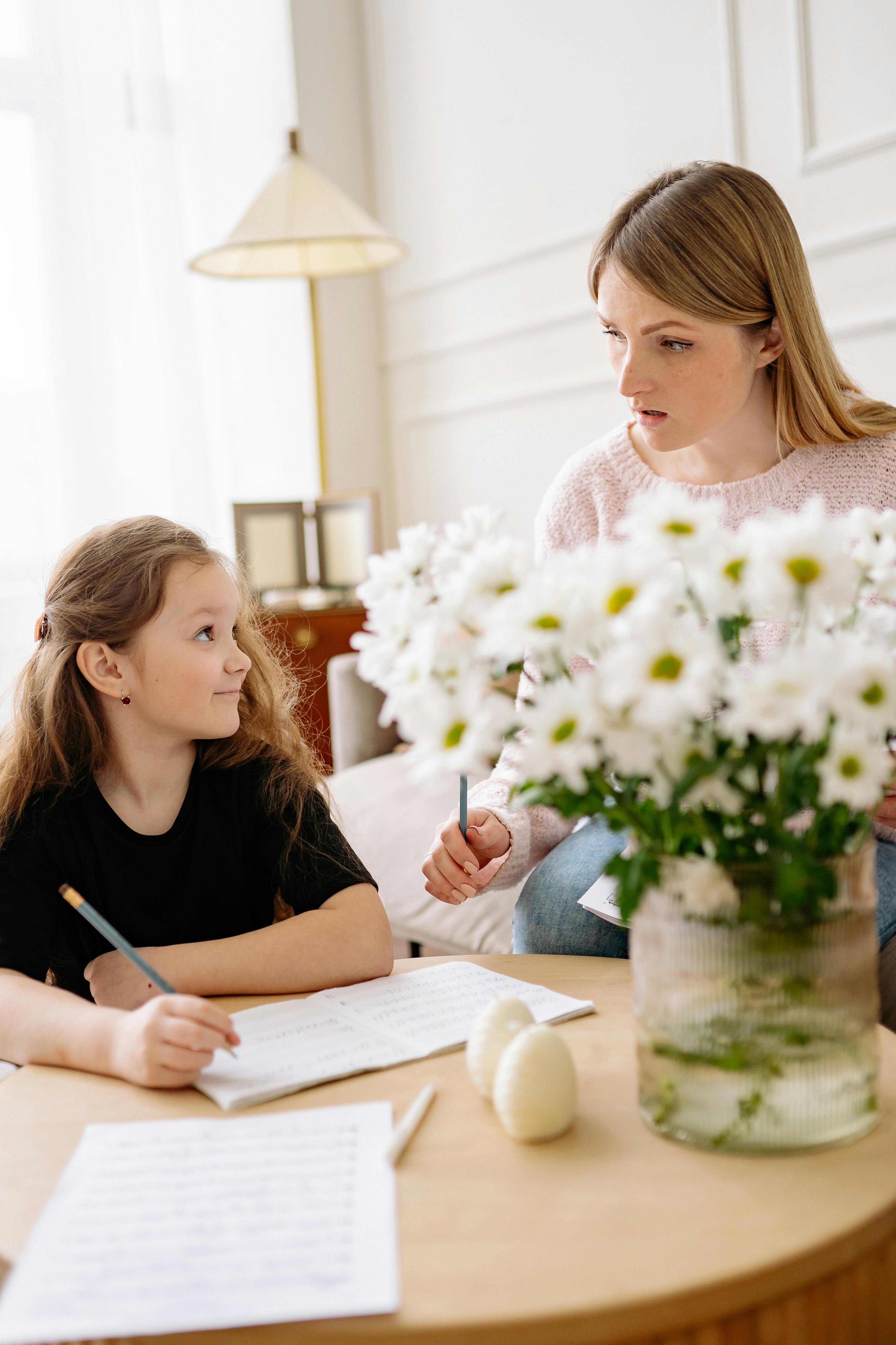 mother and daughter sitting at the table