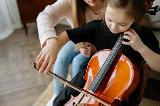 A child learning to play the cello with teacher guidance in a cozy indoor setting.