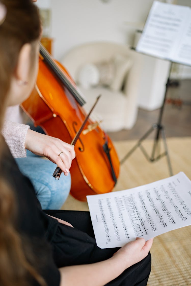 Child Looking At A Cello