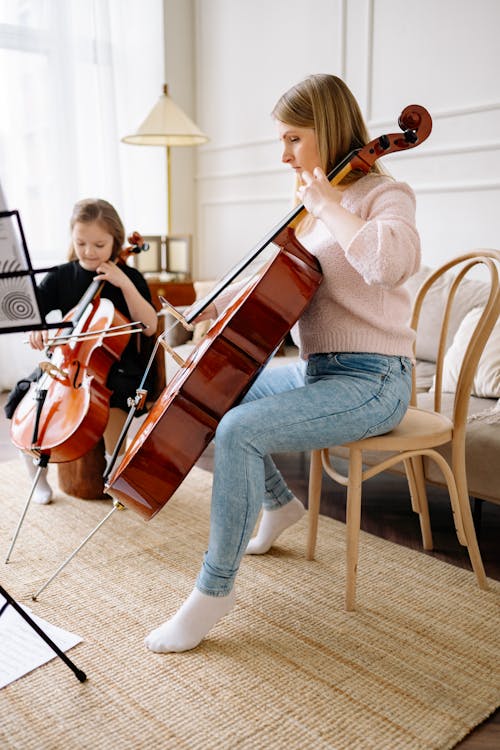 Woman and a Girl Playing Cello Together
