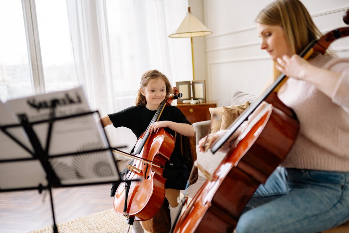 Free Woman and Child Playing Cellos Together Stock Photo