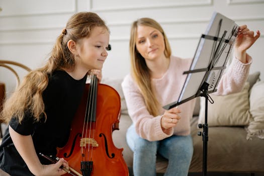 A young girl receiving cello lessons from a woman tutor, focusing on music notes indoors.