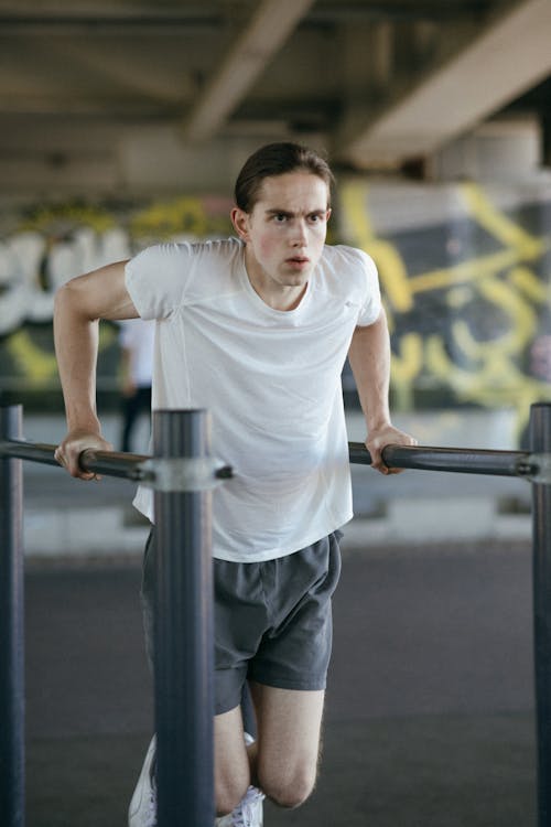 A Man in White Shirt Exercising