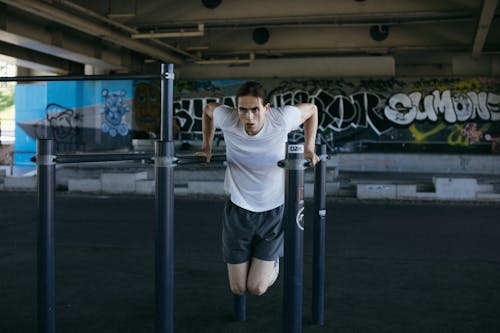 A Man in White Shirt Exercising