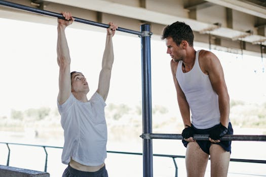 Two men engage in outdoor calisthenics workout, focusing on strength and fitness.