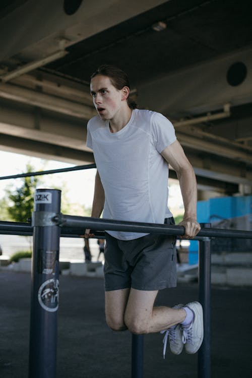 A Man in White Shirt Exercising