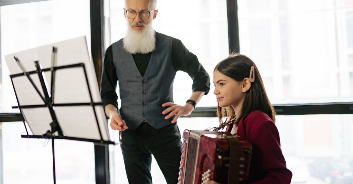 artist mentoring young musicians in a community center
