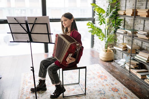Child sits indoors playing accordion during music lesson, surrounded by books and plants.