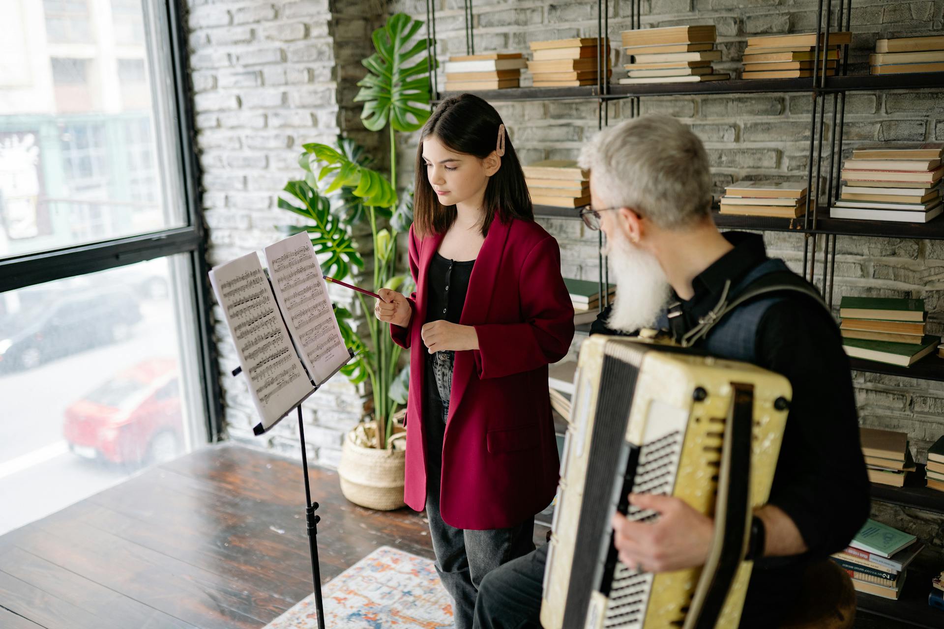 man Teaching a Kid To Play an Piano Accordion