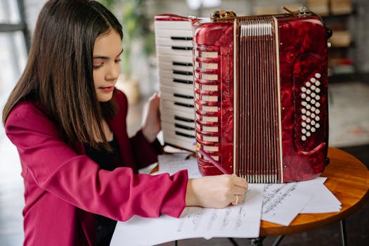 Girl learning to play the accordion with musical sheets in a cozy indoor setting.