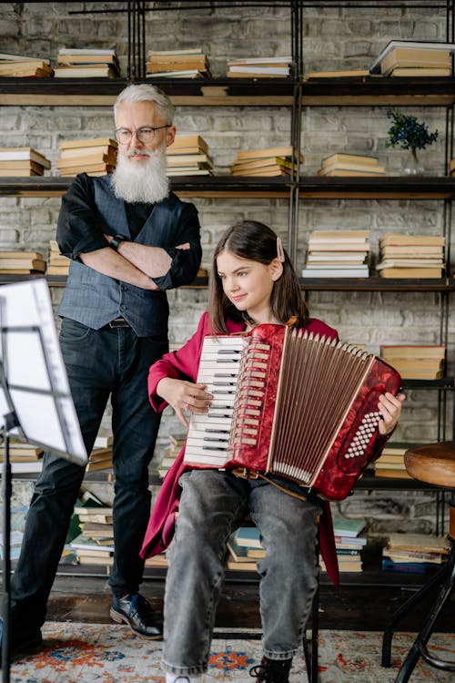 Free A Man Teaching a Girl How to Play an Accordion Stock Photo