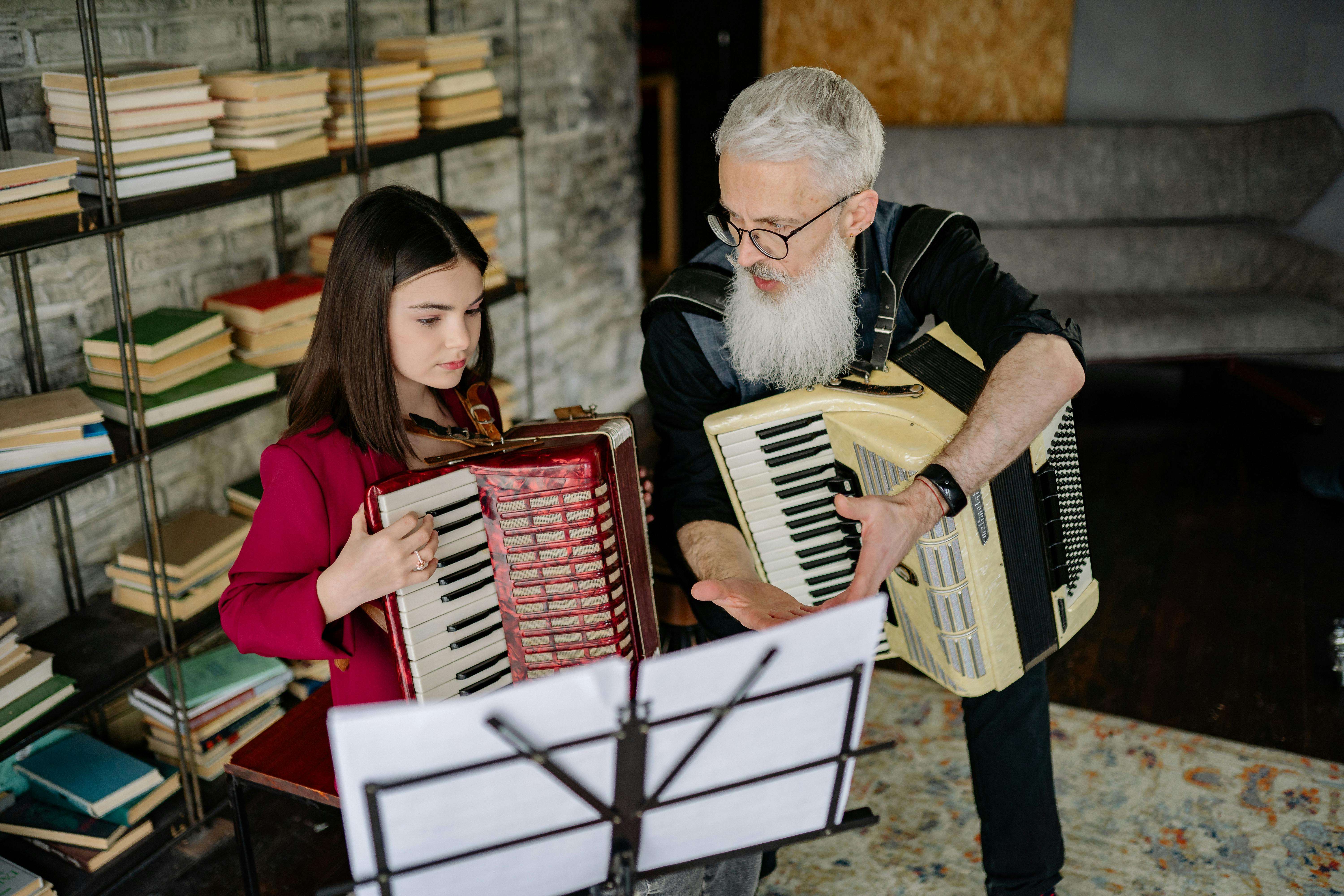 a bearded man talking to the girl while holding an accordion