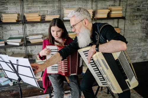 A Man and a Girl Playing Accordions
