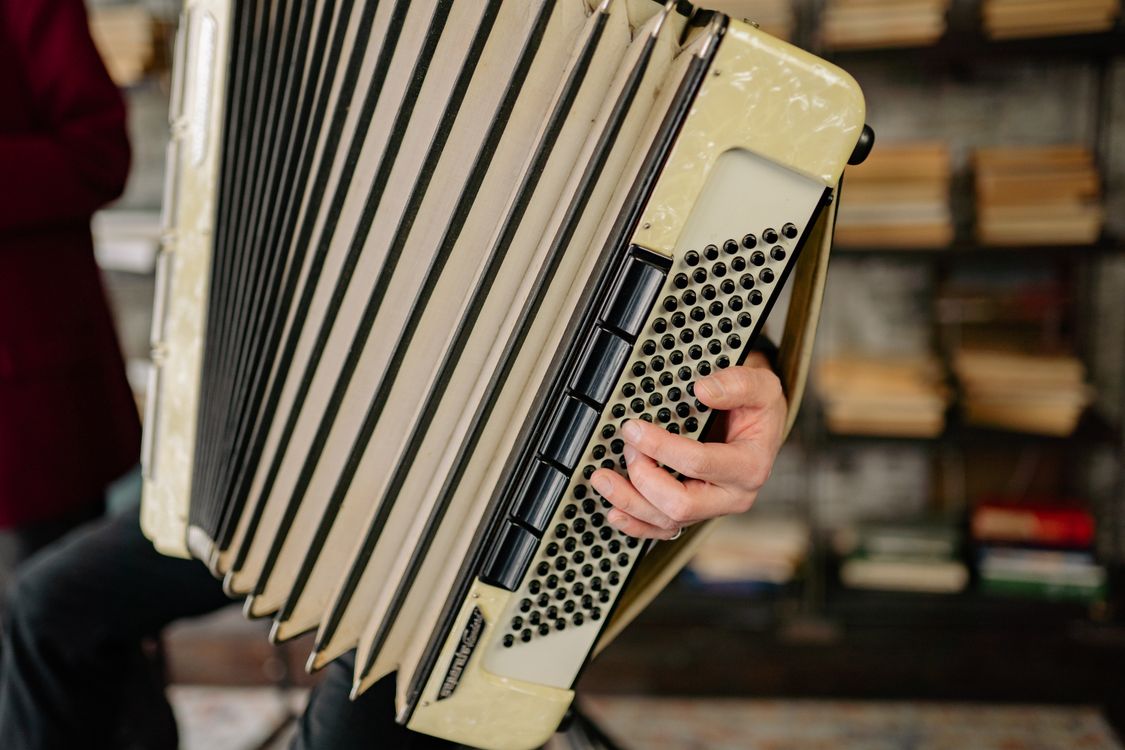 Close Up Photo of a Person Holding an Accordion · Free Stock Photo