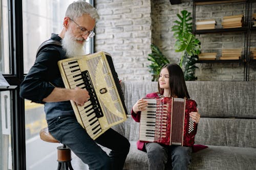 Free A Man and a Girl Playing Accordions Stock Photo