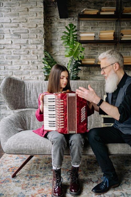 Free A Man Teaching a Girl How to Play an Accordion Stock Photo