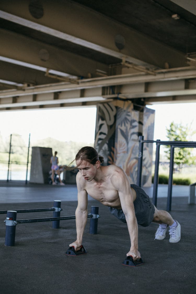 Topless Man In Black Shorts Doing Exercise