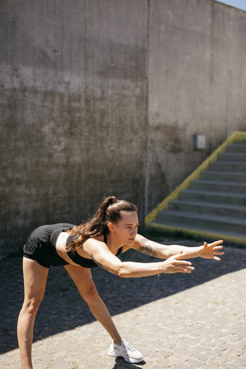 Woman Doing Bending Near a Stairs