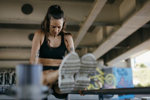 A fit woman performing an exercise on a bar under a bridge. Active and healthy lifestyle.