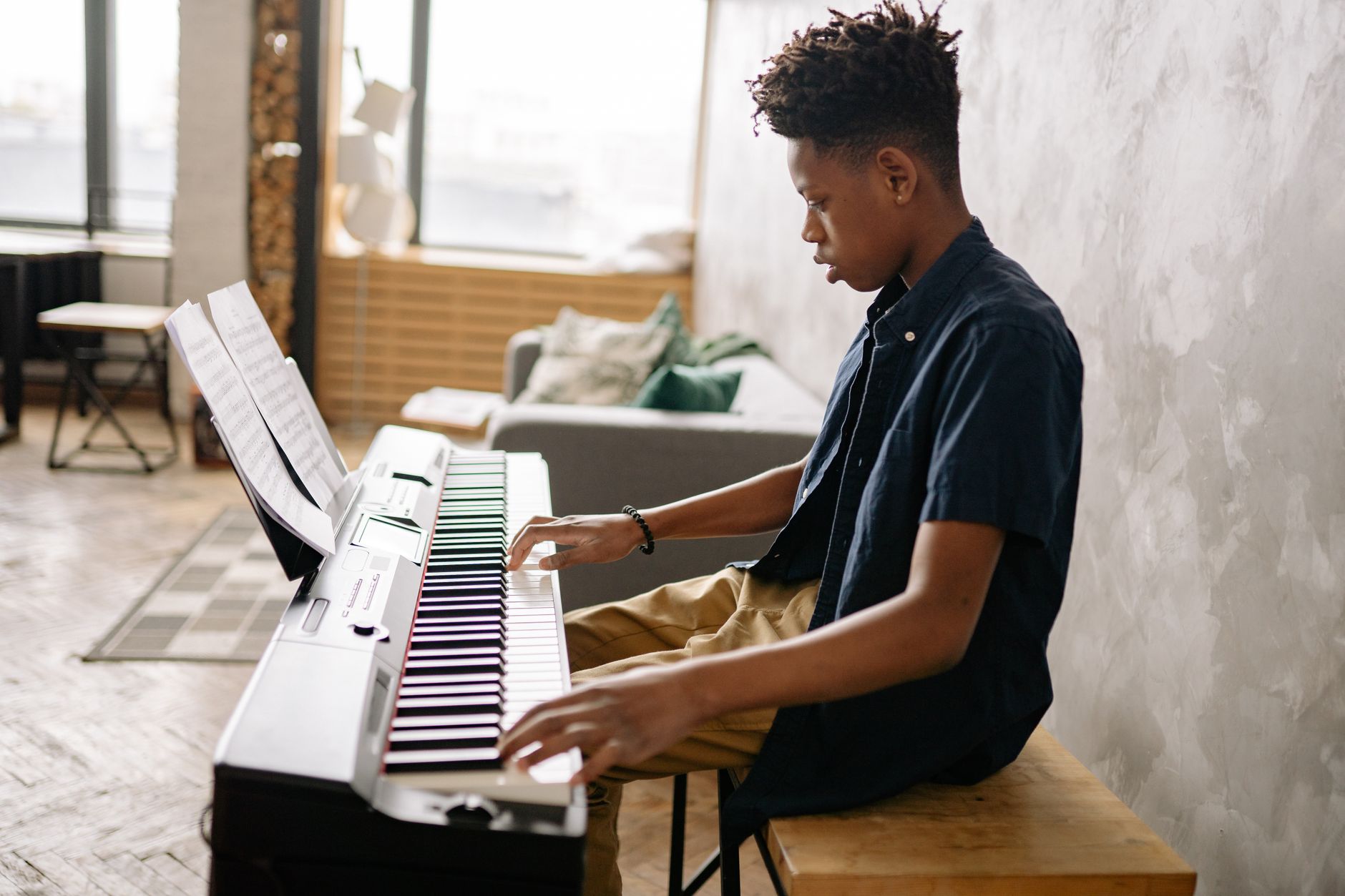 Digital pianos offer essential features for young learners like headphone jacks for quiet practice and volume control, making them ideal for home environments.