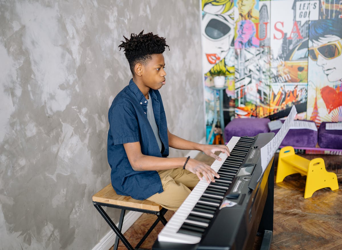 Young child smiling while playing piano