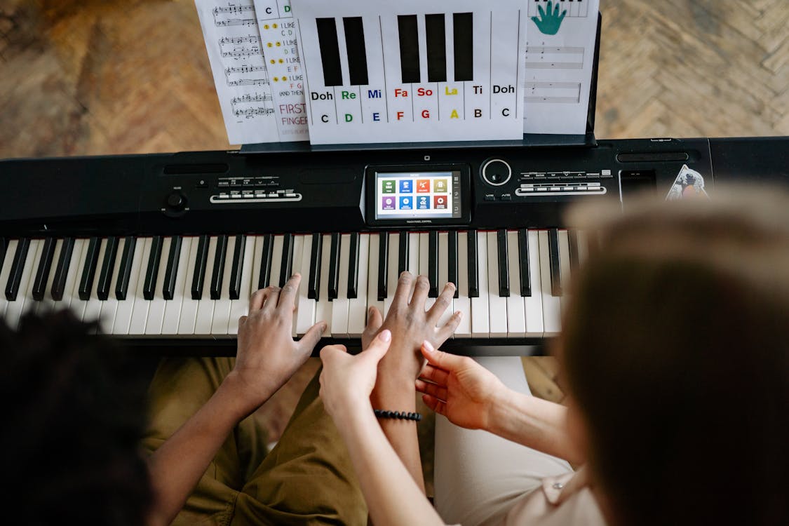 Free Person Learning How to Play Piano Stock Photo