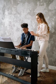 A young boy and female instructor learning and teaching piano indoors.