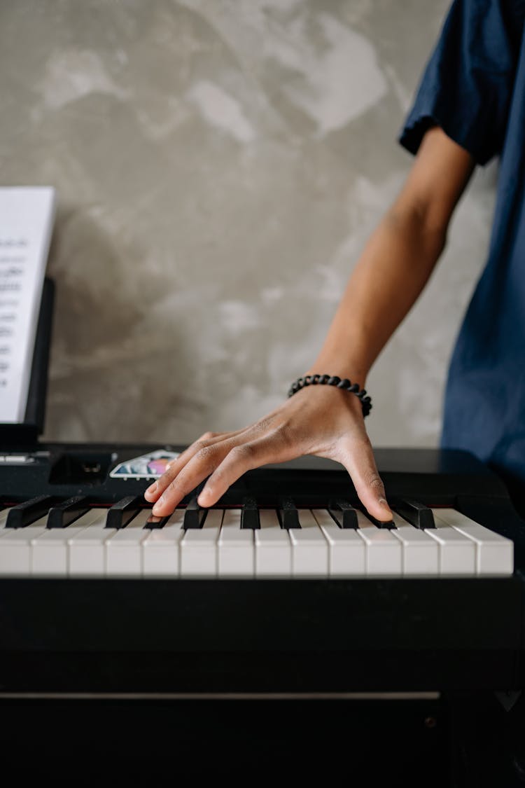 Hand Touching Piano Keys