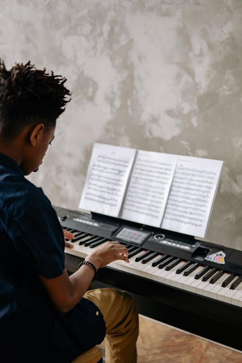 Free Young Boy Playing the Piano Stock Photo