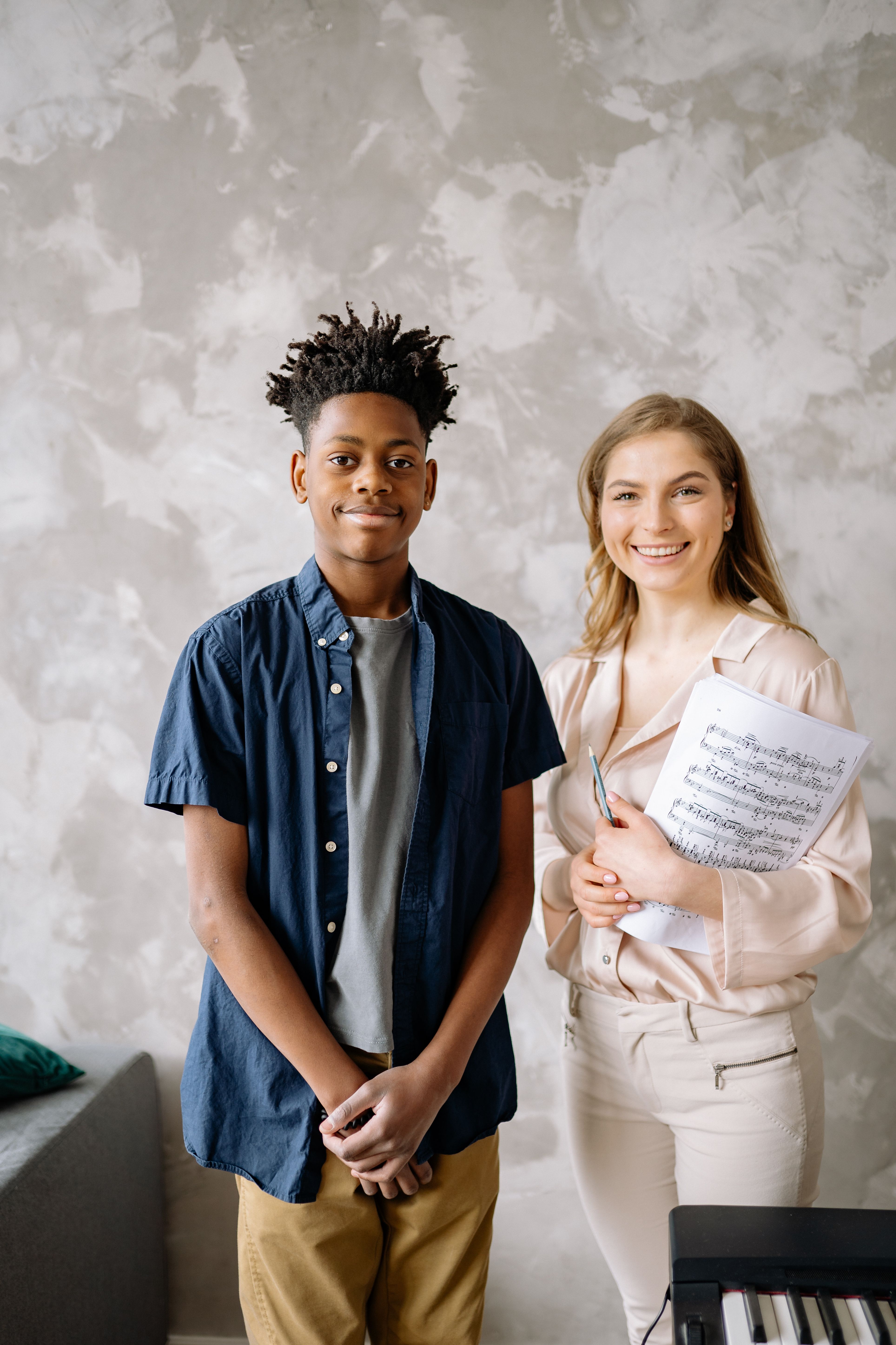 Music School Management System — Teacher and student during a music lesson with a piano