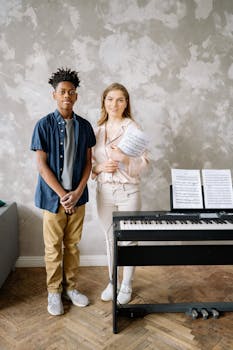 Teen and adult in a piano lesson, holding sheet music, indoors.