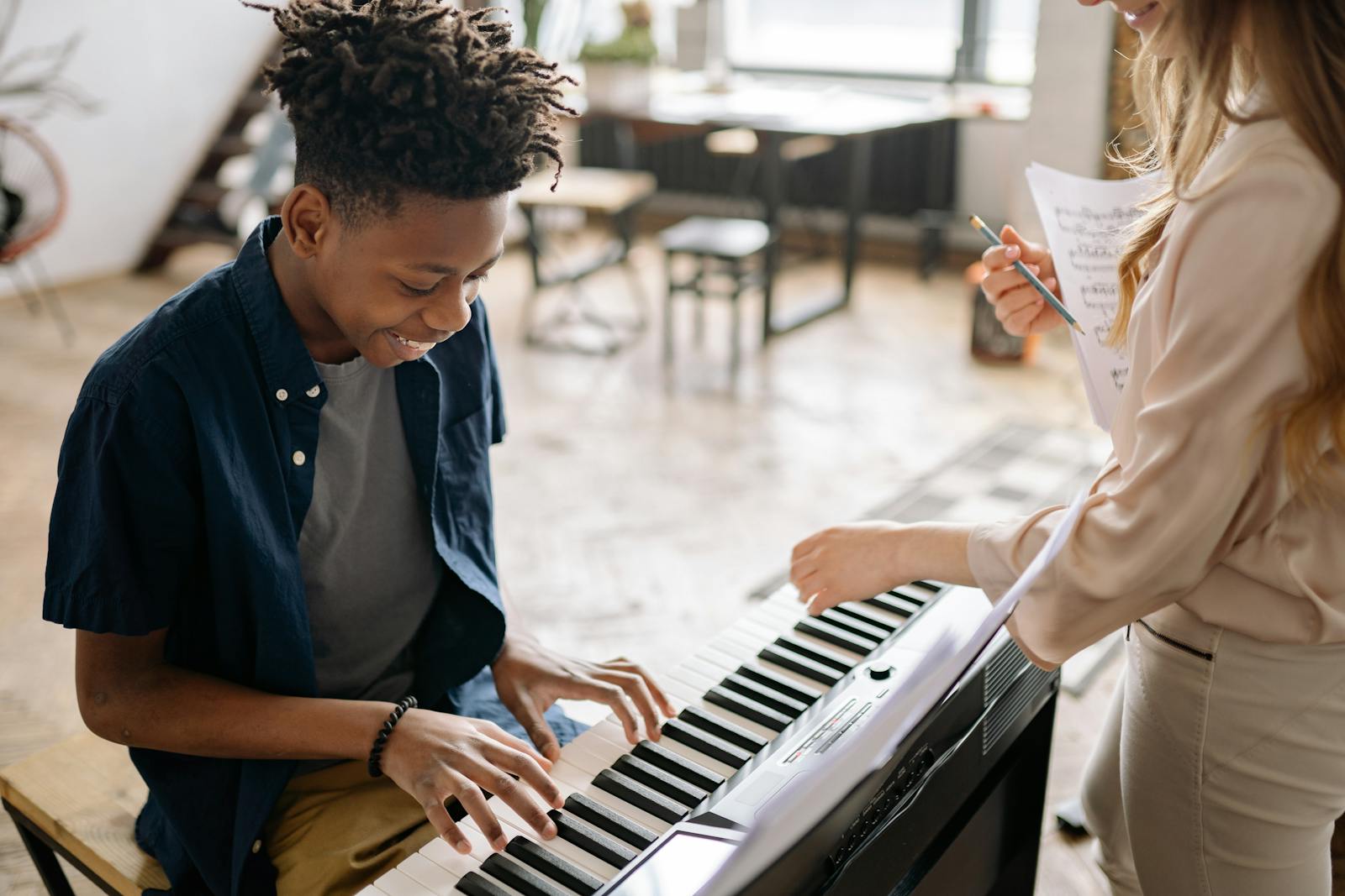 Child enjoying a piano lesson at HarmonyHouse
