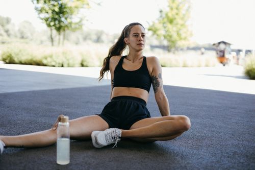 Woman sitting on the floor after a workout