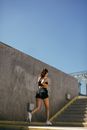Woman in Black Tank Top and Black Shorts Running