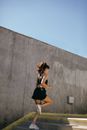 Woman in Black Tank Top and Black Shorts Running on Concrete Steps