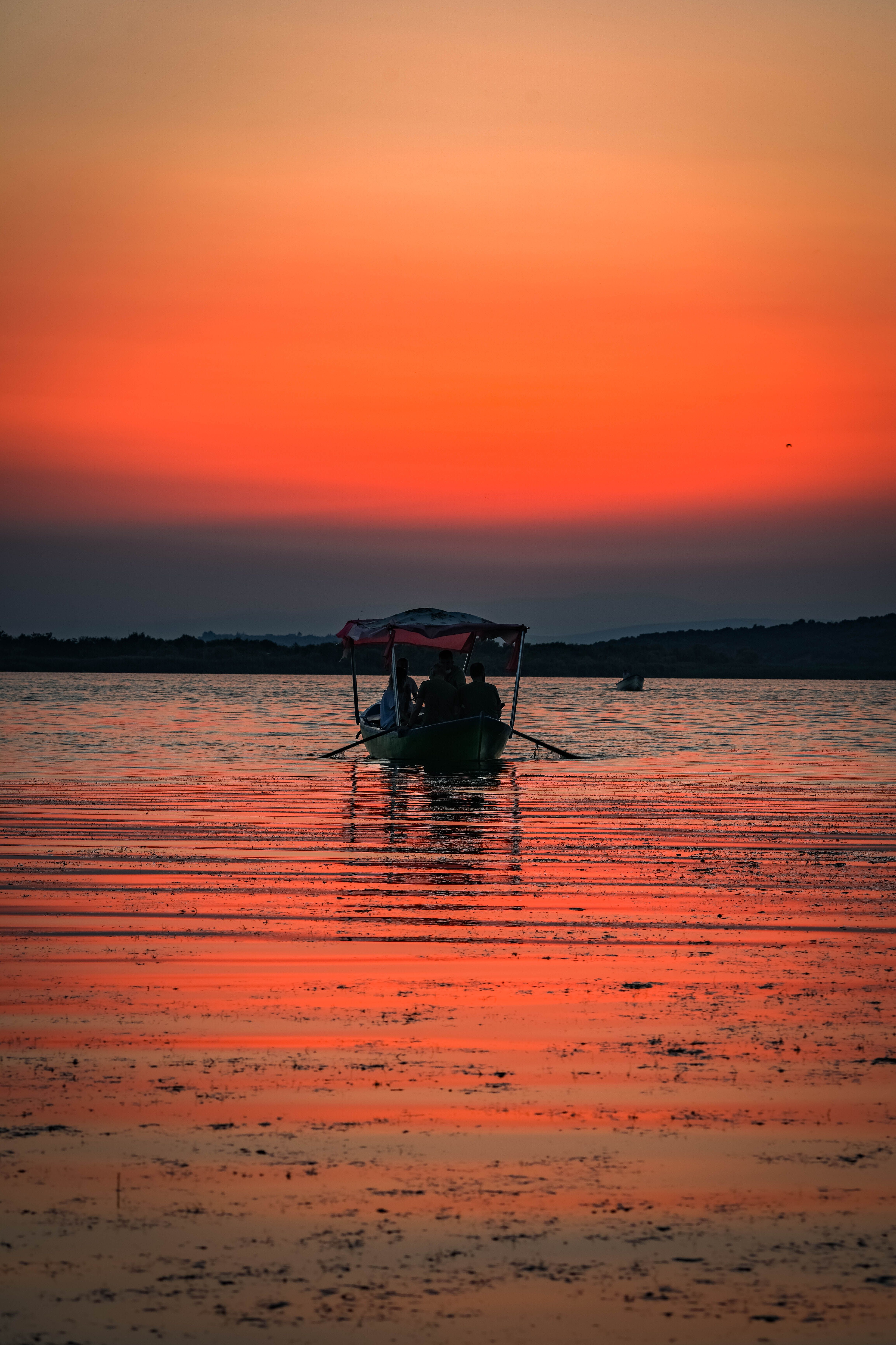 Silhouette Of Man On Boat In Water · Free Stock Photo